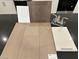 Image showcasing a countertop, flooring, a faucet and cabinet material samples at 124 Silver Run Ln, Las Vegas, NV 89138