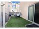 Cozy backyard features artificial turf, outdoor seating, and sliding glass door access at 1259 Plum Canyon St, Las Vegas, NV 89142