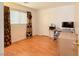 Bedroom with a desk, wood floors, and a window at 1259 Plum Canyon St, Las Vegas, NV 89142