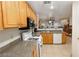 Functional kitchen featuring oak cabinets, granite countertops, and white appliances at 1259 Plum Canyon St, Las Vegas, NV 89142