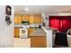 Bright kitchen with oak cabinets, granite counters, and an open layout to the dining area at 1259 Plum Canyon St, Las Vegas, NV 89142
