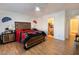 Comfortable main bedroom featuring wood floors, a ceiling fan, and easy access to the bathroom at 1259 Plum Canyon St, Las Vegas, NV 89142