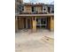 Unfinished exterior elevation with wood framing and stacked roof tiles shows the home's construction process at 136 Silver Run Ln, Las Vegas, NV 89138