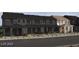 Row of townhouses in a suburban neighborhood featuring landscaped front yards at 136 Silver Run Ln, Las Vegas, NV 89138