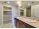 Bright bathroom featuring double sinks, stone countertops, closet and stone shower at 150 Las Vegas Blvd # 2003, Las Vegas, NV 89101