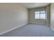 Neutral-toned bedroom with gray carpet, baseboards, and one sunny window with views at 150 Las Vegas Blvd # 2003, Las Vegas, NV 89101