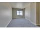 Bright bedroom with gray carpet, baseboards, and sunny window with city views at 150 Las Vegas Blvd # 2003, Las Vegas, NV 89101