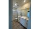 Modern bathroom with double sinks, a sleek vanity, and a walk-in shower with glass doors at 1533 Bat Hawk St, Las Vegas, NV 89144