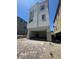 Modern three-story home featuring a two-car garage and brick paved driveway at 1533 Bat Hawk St, Las Vegas, NV 89144