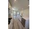 Bright, open kitchen with white cabinetry, stainless appliances, and a view of the living area at 1533 Bat Hawk St, Las Vegas, NV 89144