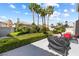 Lush backyard with tall palm trees, manicured hedges and outdoor seating area at 1680 Sweet Pea Ave, Las Vegas, NV 89183