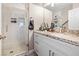 Updated bathroom features stone countertops, a shower with glass door, and bright vanity lighting at 1680 Sweet Pea Ave, Las Vegas, NV 89183