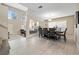 Dining room with large windows, view into the living room, and tile flooring at 1680 Sweet Pea Ave, Las Vegas, NV 89183