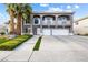 Charming two-story home with a three car garage, lush landscaping, and inviting curb appeal at 1680 Sweet Pea Ave, Las Vegas, NV 89183