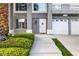 Close up of the front entrance with a three car garage and lush landscaping in front at 1680 Sweet Pea Ave, Las Vegas, NV 89183