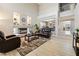 Spacious living room featuring a fireplace, wood-style tile flooring, and stylish furniture at 1680 Sweet Pea Ave, Las Vegas, NV 89183