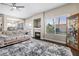 Inviting living room featuring a cozy fireplace, plush rug and lots of natural light at 1680 Sweet Pea Ave, Las Vegas, NV 89183