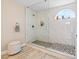 Luxurious shower featuring stylish stone flooring, marble-look tile, and bright natural light at 1680 Sweet Pea Ave, Las Vegas, NV 89183