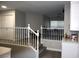 Carpeted staircase with white railing, leads to an upstairs living area and bedrooms at 1680 Sweet Pea Ave, Las Vegas, NV 89183
