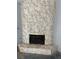 Unique stone fireplace with gold trim and hearth in a bright, naturally lit living room at 2100 Plaza Del Padre, Las Vegas, NV 89102