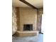 Close up view of a brick fireplace with hearth in a living room with retro wallpaper at 2100 Plaza Del Padre, Las Vegas, NV 89102