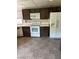 Kitchen with white appliances, dark cabinetry, tile countertops and updated floors at 2100 Plaza Del Padre, Las Vegas, NV 89102