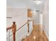 Bright hallway with wood floors, cabinet storage, and white railing staircase at 2104 Spanish Town Ave, North Las Vegas, NV 89031