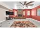 The living room has a stone fireplace with lots of light from the backyard windows at 2104 Spanish Town Ave, North Las Vegas, NV 89031