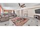 Spacious living room with large rug, ceiling fan and direct view into the open kitchen at 2104 Spanish Town Ave, North Las Vegas, NV 89031