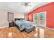 Spacious bedroom featuring wood floors, a red accent wall, and balcony access at 2104 Spanish Town Ave, North Las Vegas, NV 89031