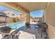 Relaxing backyard patio with comfortable wicker seating and a refreshing swimming pool at 2104 Spanish Town Ave, North Las Vegas, NV 89031