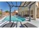 Gorgeous backyard oasis with a sparkling pool, pergola, and outdoor seating at 2104 Spanish Town Ave, North Las Vegas, NV 89031