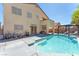 Stunning backyard with pool, covered patio, lounge chairs, and elegant landscaping at 2104 Spanish Town Ave, North Las Vegas, NV 89031