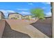Low maintenance backyard with gravel, pavers, and a wall surrounding the outdoor space at 2228 Sky Island Dr, Henderson, NV 89002