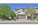 Charming two-story home featuring a tile roof, neutral stucco, a two-car garage, and desert landscaping at 2228 Sky Island Dr, Henderson, NV 89002