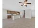 Open-concept kitchen featuring an island, stainless appliances, granite counters, and tile flooring throughout at 2228 Sky Island Dr, Henderson, NV 89002