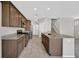 Modern kitchen featuring granite countertops, stainless steel appliances, and a central island with a sink at 2228 Sky Island Dr, Henderson, NV 89002