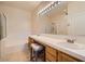 Well-lit bathroom featuring double sinks, vanity, a large mirror, a separate bathtub, and a shower at 2325 Windmill Pkwy # 312, Henderson, NV 89074