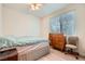Bright bedroom with light wood floors and a large window at 2325 Windmill Pkwy # 312, Henderson, NV 89074