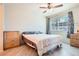 Cozy bedroom with light wood floors, ceiling fan, and natural light at 2325 Windmill Pkwy # 312, Henderson, NV 89074