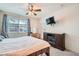 Cozy bedroom featuring a ceiling fan, television, and fireplace for ultimate relaxation and comfort at 2325 Windmill Pkwy # 312, Henderson, NV 89074