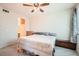 Bright bedroom with a ceiling fan, neutral walls, and a large window offering natural light at 2325 Windmill Pkwy # 312, Henderson, NV 89074