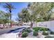 Community entrance featuring lush landscaping and clear signage at 2325 Windmill Pkwy # 312, Henderson, NV 89074