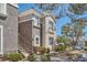 Exterior showcasing well-maintained landscaping, desert foliage, a private balcony, and neutral stucco at 2325 Windmill Pkwy # 312, Henderson, NV 89074
