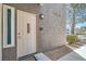 Charming front door with stylish welcome sign, neutral paint, and manicured desert landscaping at 2325 Windmill Pkwy # 312, Henderson, NV 89074
