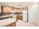 Bright kitchen featuring wooden cabinets, white countertops, and appliances at 2325 Windmill Pkwy # 312, Henderson, NV 89074