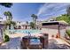 Inviting community pool and spa area with lounge chairs and umbrellas for residents at 2325 Windmill Pkwy # 312, Henderson, NV 89074