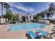 Community pool area with lounge chairs, palm trees and shade at 2325 Windmill Pkwy # 312, Henderson, NV 89074