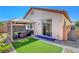 Well-designed backyard with an outdoor seating area under a gazebo and lush turf at 248 Windmill Croft Dr, Las Vegas, NV 89148