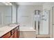Bright bathroom featuring a double sink vanity and a glass shower at 248 Windmill Croft Dr, Las Vegas, NV 89148